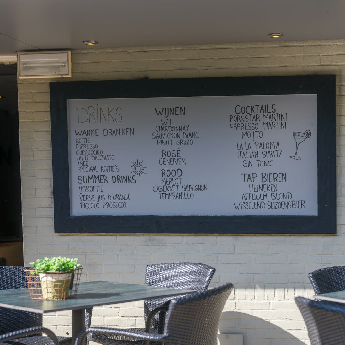 The image shows a menu board with drinks and food.