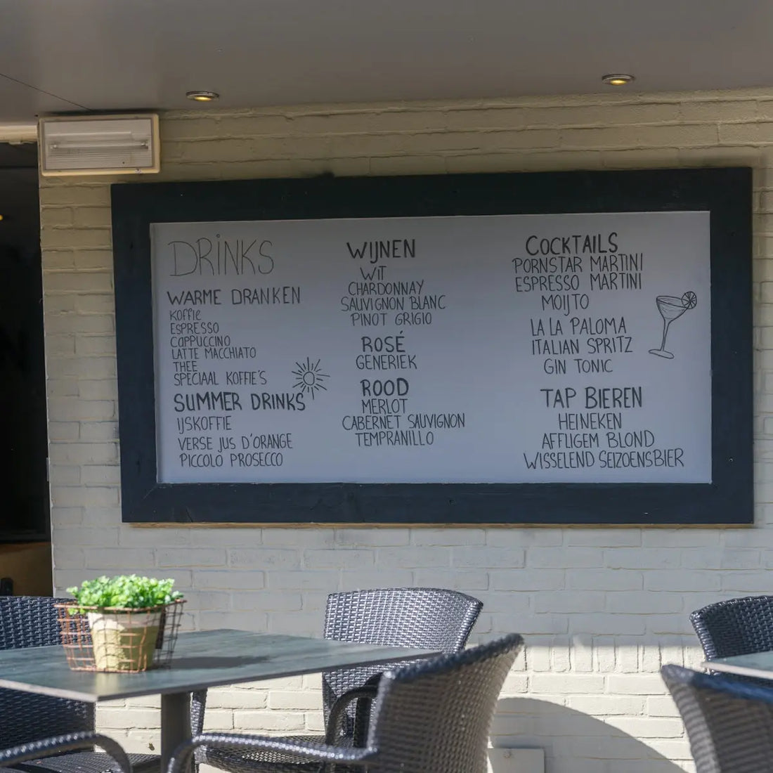 The image shows a menu board with drinks and food.