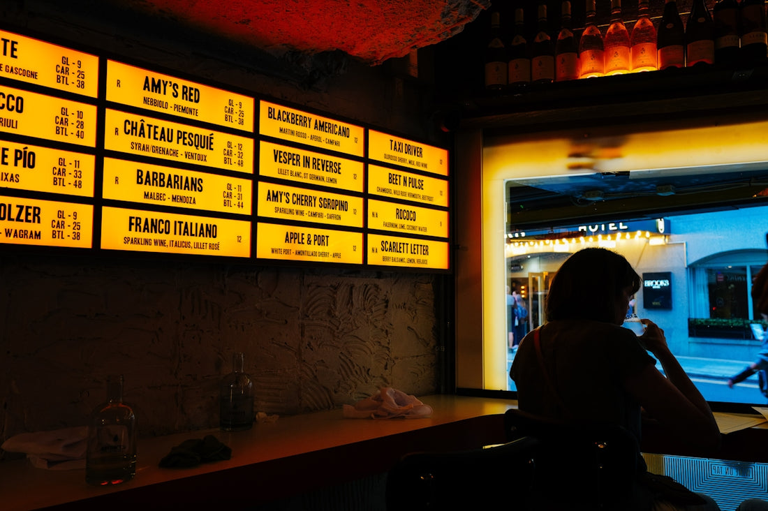 Illuminated menu board above a bar counter
