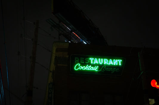 Green neon sign for restaurant and cocktail lounge.